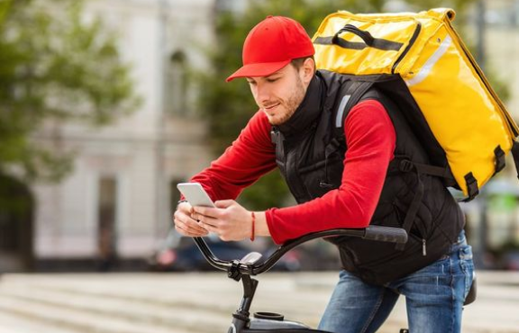 A delivery man on a bike