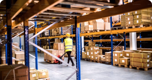 A man moving boxes in a warehouse